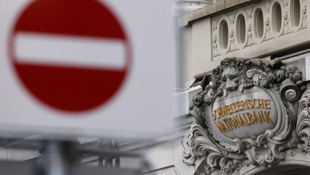 A sign above the entrance to the Swiss National Bank (SNB) ahead of the bank's rate announcement news conference in Bern, Switzerland, on Thursday, Dec. 14, 2023. With Switzerland facing the weakest growth in four years for 2024, inflation now down to 1.4%, and the franc close to at an eight-year high against the euro, the central bank is in a holding pattern. Photographer: Stefan Wermuth/Bloomberg