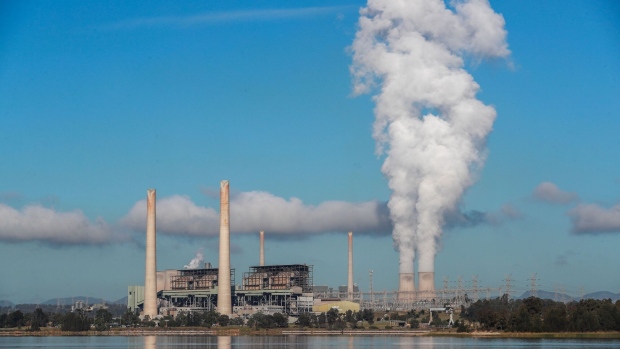 MUSWELLBROOK, AUSTRALIA - APRIL 27: Liddell Power Station stands next to Lake Liddell as chimneys at the Bayswater Power Station emit water vapour on April 27, 2023 in Muswellbrook, Australia. Liddell Power Station, one of Australia's oldest coal-fired power plants, will shut down on Friday, 28 April, after 52 years in operation. The AGL-owned facility opened in 1971 and was once the most powerful generating station in Australia. With Australia making the transition from coal power to renewables, the site will be transformed into a new low-carbon industrial energy hub. Demolition of the plant will begin next year, with more than 90 per cent of the materials to be recycled, AGL says. The closure of Liddell Power Station will stop 8 million tonnes of Carbon dioxide being released into the atmosphere every year, media reported. (Photo by Roni Bintang/Getty Images)