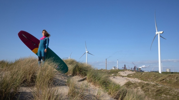  Dutch longboard surf champion Anna Albers on the sand dunes in the coastal village of Wijk aan Zee, Netherlands, on May 17. Photographer: Peter Boer/Bloomberg