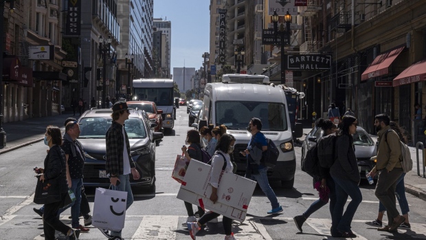 Pedestrians carry shopping bags in San Francisco.