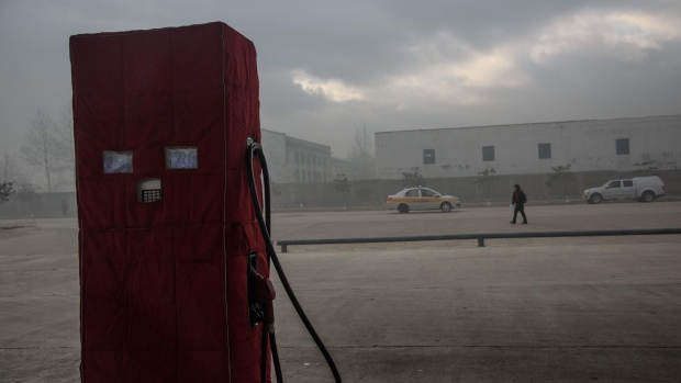 In photo taken on November 20, 2017 cars pass a petrol pump in North Korea's border city of Rason, adjaecent to Russia and China.  Photographer: Ed Jones/AFP/Getty Images