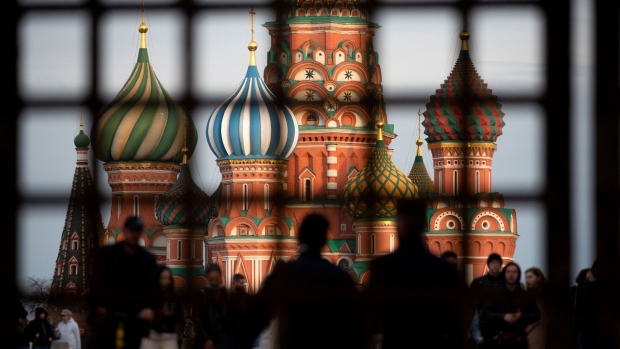 Pedestrians walk by Saint Basil's Cathedral on Red Square in Moscow, Russia, on Sunday, May 2, 2021. Facing a rising wave of Covid-19 infections and a vaccination rate that isn’t keeping up, the Kremlin is trying to contain the epidemic without alarming Russians.
