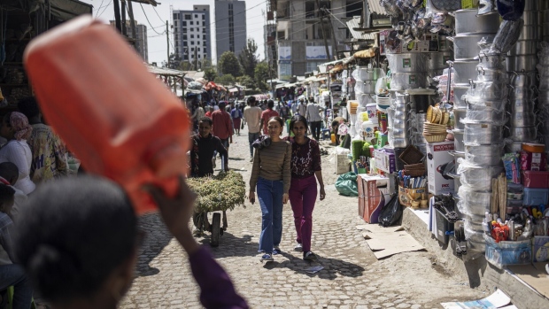 Shoppers and residents walk through the Shola market in Addis Ababa, Ethiopia.