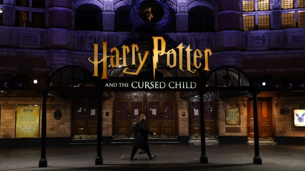 A pedestrian walks past the 'Harry Potter and the Cursed Child' show theatre in the West End district in London, U.K., on Friday, March 20, 2020. A shutdown of the U.K. capital would hit the night-time economy hard -- one in three employees in London works between 6 p.m. and 6 a.m., many in the pubs, restaurants and clubs most at risk of survival because of the pandemic.