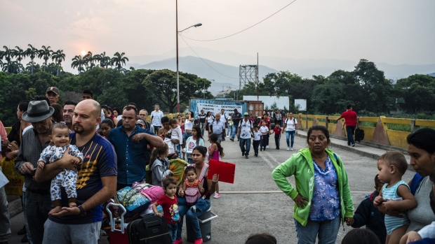 Venezuelans stop at a Colombian migration checkpoint while crossing the Simon Bolivar International Bridge near the Venezuelan border in Cúcuta, Colombia, on Wednesday, March 27, 2019.