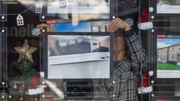 An employee places an advert in the window of an estate agents in Braintree, UK, on Thursday, Dec. 21, 2023. The downturn in the UK housing market steepened in October, with the average cost of a home sliding 1.2% from a year earlier as higher interest rates stymied activity.