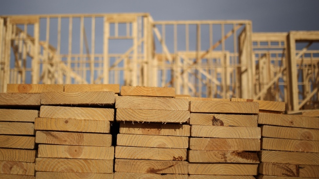 Lumber sits stacked in front of wooden framing during the construction of residential housing in Kentucky, U.S. Photographer: Bloomberg Creative Photos/Bloomberg