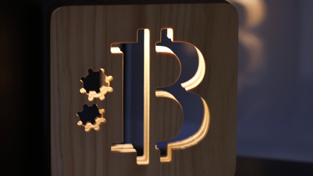 A wooden Bitcoin logo inside a cryptocurrency exchange in Barcelona, Spain, on Tuesday, Dec. 5, 2023. Bitcoin shrugged off a slide in global markets during a rally to a more than 19-month high, a sign of its decoupling from other assets.