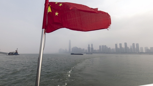 A Chinese flag on a ferry crossing the Yangtze River in Wuhan, China, on Tuesday, Feb. 7, 2023. After imposing three years of sacrifice, Chinese President Xi Jinping's government let Covid tear through the population in two months. Moving on won’t be easy. Photographer: Qilai Shen/Bloomberg