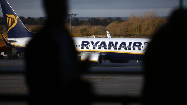 Passengers watch a Ryanair Holdings Plc aircraft approach the terminal building at Dublin Airport, operated by Dublin Airport Authority, in Dublin, Ireland, on Friday, Nov. 25, 2016. Ryanair provides low fare passenger airline services to destinations in Europe.