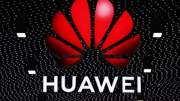 An illuminated logo stands above the Huawei Technologies Co. stand during the opening day of the MWC Barcelona in Barcelona, Spain, on Monday, Feb. 25, 2019.  Photographer: Stefan Wermuth/Bloomberg