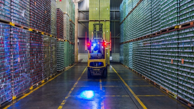A worker drives a forklift truck to transport a crate of aluminum cans in the warehouse at the Nampak Ltd. Bevcan Springs manufacturing plant in Springs, South Africa, on Thursday, Aug. 13, 2020. Manufacturing production, mining output and retail sales plunged in South Africa in the three months through June as the country imposed a strict lockdown on March 27 that shuttered almost all activity except essential services for five weeks.