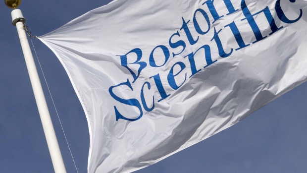 UNITED STATES - JANUARY 12: The company flag flies in front of Boston Scientific Headquarters in Natick, Massachusetts Thursday, January 12, 2006. Guidant Corp., after accepting an increased takeover bid from Johnson & Johnson, invited Boston Scientific to sweeten its $25 billion offer for the troubled cardiac-device maker, an analyst said. (Photo by Jb Reed/Bloomberg via Getty Images) Photographer: Bloomberg/Bloomberg