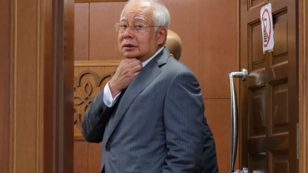 Najib Razak, Malaysia's former prime minister, pauses while walking through the Kuala Lumpur Courts Complex in Kuala Lumpur, Malaysia, on Wednesday, March 13, 2019. Criminal trials in Malaysia should start no later than 90 days since the charges were served, but it has been eight months since Najib received the first of 42 counts of corruption and embezzlement he faces for his alleged role in 1MDB. Najib has consistently denied any wrongdoing.