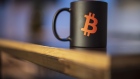 A Bitcoin logo on a mug. Photographer: Milan Jaros/Bloomberg
