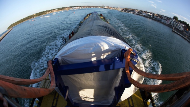 A V164 80-metre long wind turbine blade, manufactured by MHI Vestas Offshore Wind A/S, leaves Cowes on the Bladerunner II transport vessel on the Isle of Wight, U.K., on Friday, July 17, 2020. The offshore wind market will probably continue to grow faster than its onshore counterpart because the large size and scale of machines sited at sea.