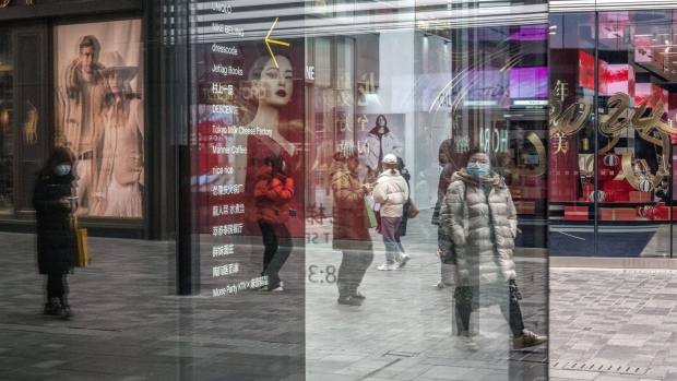 Pedestrians reflected in a window in Beijing, China, on Tuesday, Jan. 2, 2024. Chinese President Xi Jinping pledged to strengthen economic momentum and job creation, acknowledging some companies and citizens had endured a difficult 2023 in a rare admission of domestic headwinds facing the country. Source: Gilles Sabri/Bloomberg
