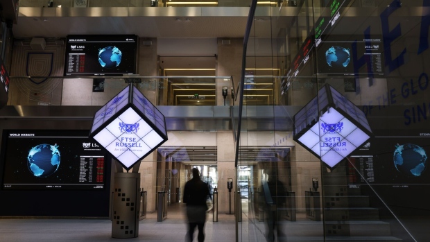 An office worker walks through the London Stock Exchange Group Plc's atrium in the City of London, UK, on Wednesday, Jan. 3, 2024. The FTSE 100, launched on Jan. 3, 1984, was one of many innovations that transformed the City of London in the 1980s.