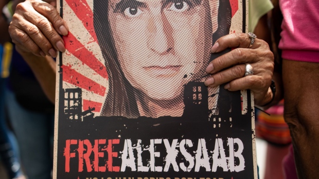A demonstrator holds a poster that reads "Free Alex Saab" during a rally in support of Colombian businessman and close ally of Venezuelan President Nicolas Maduro in the Petare neighborhood of Caracas, Venezuela, on Monday, April 4, 2022.  Extradited to the U.S. last year, American authorities accused Saab of paying bribes to Venezuelan government officials in connection with contracts for a low-income housing project in the country, and then laundering the proceeds using bank accounts in Florida. Photographer: Gaby Oraa/Bloomberg