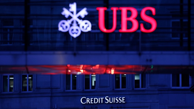 A Credit Suisse Group AG bank branch beyond a UBS Group AG office building walkway in Zurich.