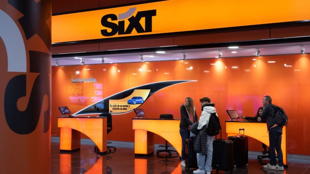 Customers at a Sixt SE vehicle rental kiosk at Palma de Mallorca Airport in Palma, Mallorca, Spain, on Monday, April 3, 2023. The summer travel season is shaping up to be a good one for European airlines, prompting Deutsche Bank AG and Barclays Plc to upgrade several carriers that could benefit from rising fares, strong demand and lower jet fuel prices.