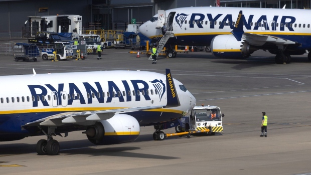 Passenger aircraft, operated by Ryanair Holdings Plc, on the tarmac at London Stansted Airport, operated by Manchester Airport Plc, in Stansted, UK, on Friday, May 26, 2023. Ticket prices across the industry have been edging higher, partly because of robust demand for summer getaways, and partly because of a scarcity of aircraft as airlines clamor to get hold of new models.