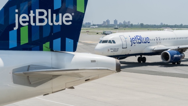 JetBlue airplanes at John F. Kennedy International Airport (JFK) in New York, US, on Sunday, July 23, 2023. JetBlue Airways Corp. is scheduled to release earnings figures on August 1. Photographer: Jeenah Moon/Bloomberg