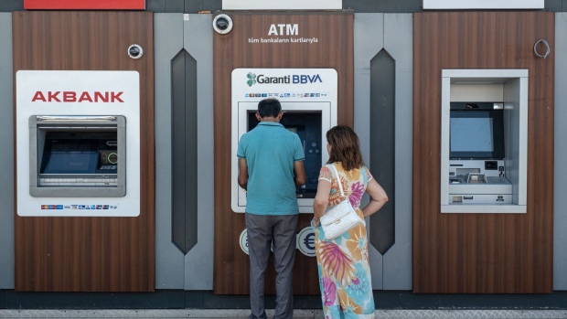 Customers use bank ATMs in Istanbul. Photographer: Kerem Uzel/Bloomberg