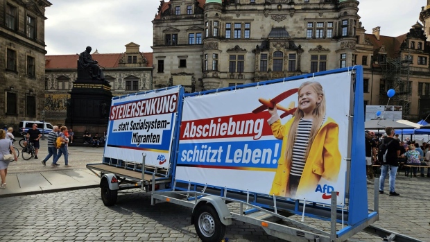 Advertising banners for the Alternative für Deutschland (AfD) reading 'Tax Reduction ... Instead of Migrant Welfare System' and 'Deportation Protects Lives' on German Unity Day in Dresden, Germany, Tuesday, on Oct. 3, 2023. Germany’s mainstream parties have been hoping that investment in places like Dresden would help them regain voters lost to the AfD. Photographer: Chris Reiter/Bloomberg