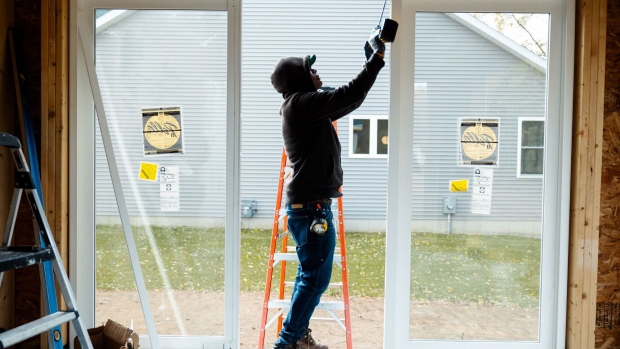 A worker uses a drill to install a window frame at a home under construction at the Cold Spring Barbera Homes subdivision in Loudonville, New York, US, on Wednesday Nov. 8, 2023. The National Association of Home Builders (NAHB) released housing market index figures on November 16.