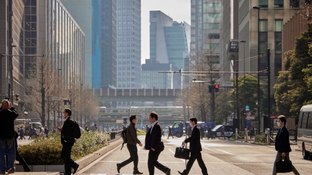 Morning Commuters cross a street near Tokyo Station in Tokyo, Japan, on Thursday, March 30, 2023. The Bank of Japan will release its quarterly Tankan business sentiment survey on April 3.