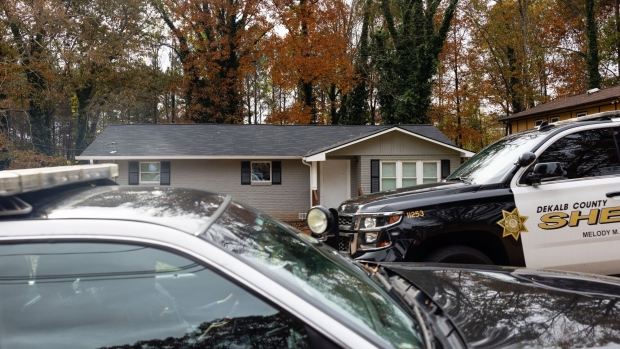 Law enforcement vehicles outside a home occupied by squatters in Atlanta.  Photographer: Elijah Nouvelage/Bloomberg