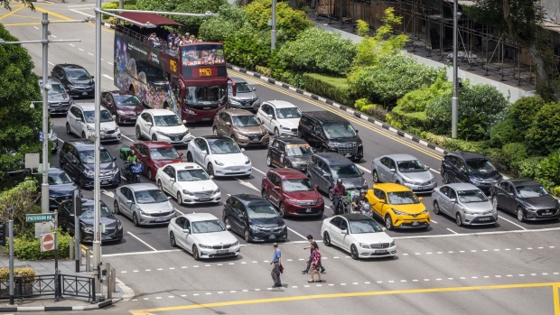 Traffic at a junction on Orchard Road in Singapore. Photographer: Edwin Koo/Bloomberg