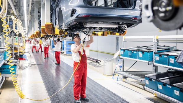 Workers install chassis components onto a Kia Ceed automobile on the assembly line at the Kia Slovakia sro plant in Zilina, Slovakia, on Friday, Oct. 27, 2023. European auto sales maintained double-digit growth in September despite higher interest rates raising the cost of acquiring a car.