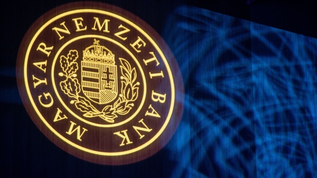 A logo for the Magyar Nemzeti Bank, the Hungarian central bank, during the Lamfalussy conference in Budapest, Hungary, on Monday, Feb. 6, 2023. Hungary and the global economy have passed the worst on inflation in part due to softer demand, National Bank of Hungary Deputy Governor Mihaly Patai told the conference.