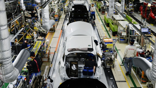 Workers assemble vehicles on the Prius hybrid and Priyus plug-in hybrid vehicle (PHV) production line of the Toyota Motor Corp. Tsutsumi plant in Toyota City, Aichi, Japan, on Saturday, Dec. 8, 2017. This year marks the 20th anniversary of the Prius, the world's first mass-produced hybrid passenger vehicle.
