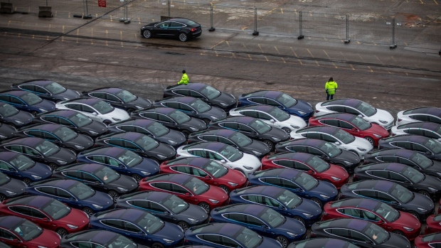 Automobiles produced by Tesla Inc. sit dockside after arriving on the Glovis Courage vehicles carrier vessel at the Port of Oslo in Oslo, Norway, on Friday, March 15, 2019. Tesla made one of the largest deliveries yet of its new Model 3 car to Norway, one of the electric-vehicle producer's biggest markets. Photographer: Odin Jaeger/Bloomberg