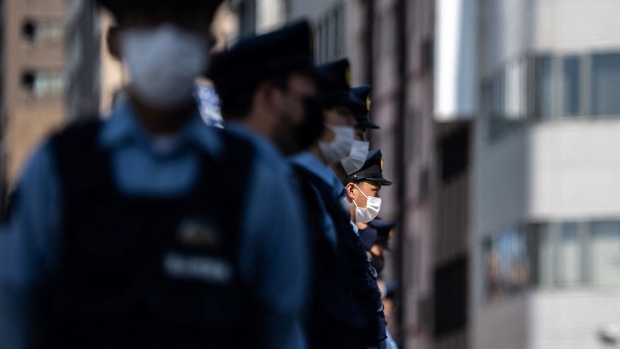 Japanese police officers stand guard. Photographer: Philip Fong/AFP/Getty Images
