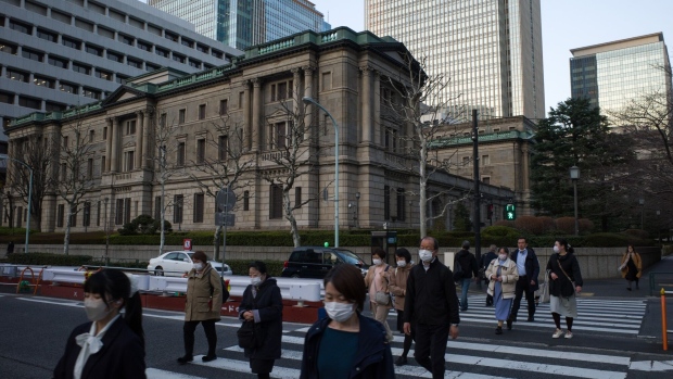 Pedestrians in front of the Bank of Japan (BOJ) headquarters in Tokyo, Japan, on Wednesday, March. 8, 2023. The Bank of Japan will conclude Governor Haruhiko Kuroda’s final meeting Friday, with global investors remaining on high alert for a surprise parting shot from Kuroda that may jolt financial markets around the world.