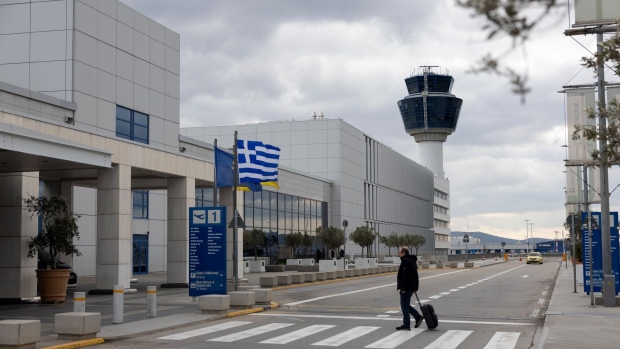 A traveler arrives at Athens International Airport SA in Athens, Greece on Jan. 24.