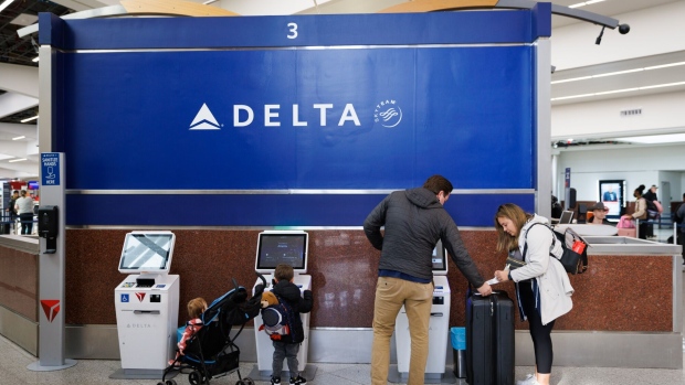 Travelers check in at a Delta kiosk at Hartsfield-Jackson Atlanta International Airport on Dec. 22.
