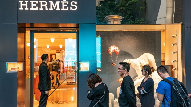 Shoppers wait in line outside a Hermes International SCA store on Canton Road in the Tsim Sha Tsui district of Hong Kong, China, on Sunday, Feb. 3, 2019. The week-long Lunar New Year holiday, starting Feb. 4, will provide the next litmus test of the resilience of the Chinese shopper. The seven-day period sees hundreds of millions of people travel within the country to see relatives, fly overseas to takevacations - and open their wallets to buy gifts.