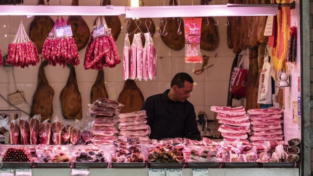 A butcher displays pork cuts at a fresh food market in Shanghai, China, on Thursday, Dec. 7, 2023. China is scheduled to release consumer price index (CPI) figures on Dec. 9. Photographer: Qilai Shen/Bloomberg