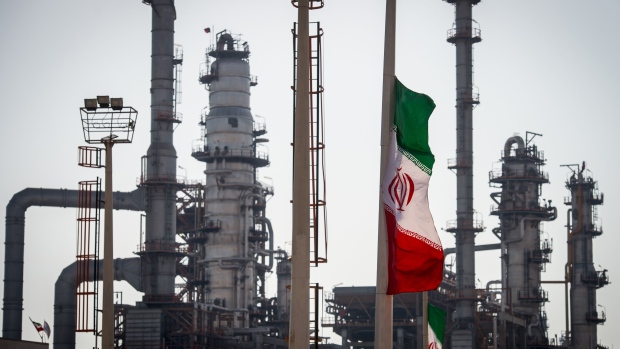 An Iranian national flag flies near gas condensate processing facilities in the new Phase 3 facility at the Persian Gulf Star Co. (PGSPC) refinery in Bandar Abbas, Iran, on Wednesday, Jan. 9. 2019. The third phase of the refinery begins operations next week and will add 12-15 million liters a day of gasoline output capacity to the plant, Deputy Oil Minister Alireza Sadeghabadi told reporters. Photographer: Ali Mohammadi/Bloomberg