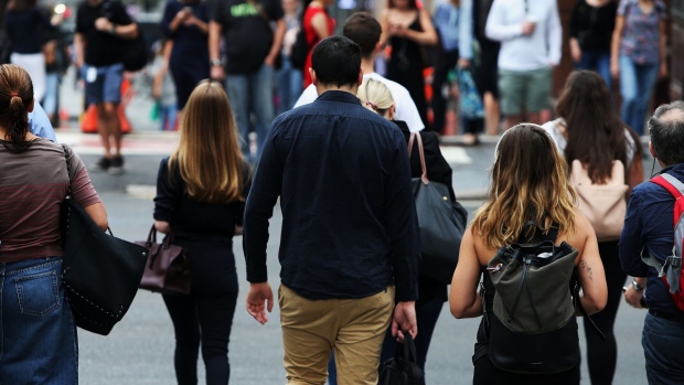 Pedestrians stand at a junction on Martin Place in the central business district in Sydney, Australia, on Friday, Jan. 11, 2019. Australian consumer confidence slumped the most in more than three years, amid pessimism over falling property prices and economic growth, after the nation's dollar tumbled to the weakest in almost 10 years at the beginning of the month.