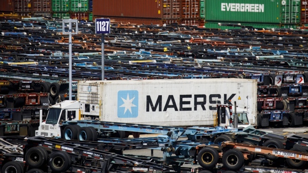 A truck transports a shipping container in the APM shipping terminal at the Port of Los Angeles in Los Angeles, California, U.S., on Tuesday, May 7, 2019. The terminal has ordered an electric, automated carrier from Finnish manufacturer Kalmar, part of the Cargotec Corp., that can fulfill the functions of three kinds of manned diesel vehicles: a crane, top-loader and truck. Photographer: Patrick T. Fallon/Bloomberg