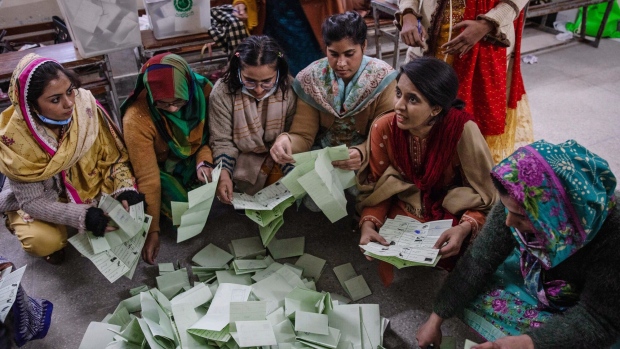 Officials count ballots at a polling station in Lahore on Feb. 8.