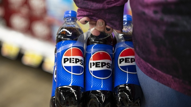 A shopper with a six pack of Pepsi in New York. Photographer: Angus Mordant/Bloomberg