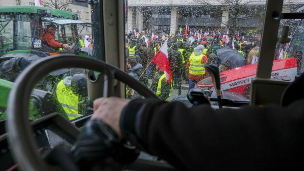 Farmers protest outside a government office in Poznan, Poland, on Feb. 9. Photographer: Damian Lemański/Bloomberg