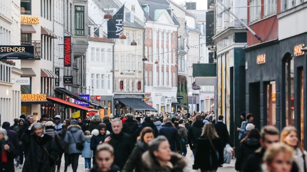 Shoppers walk along the pedestrianized Stroget shopping street in Copenhagen, Denmark, on Thursday, Jan. 3, 2019. For the first time in almost three years, the central bank of Denmark has bought kroner to support its euro peg through a direct intervention in the currency market. Photographer: Luke MacGregor/Bloomberg